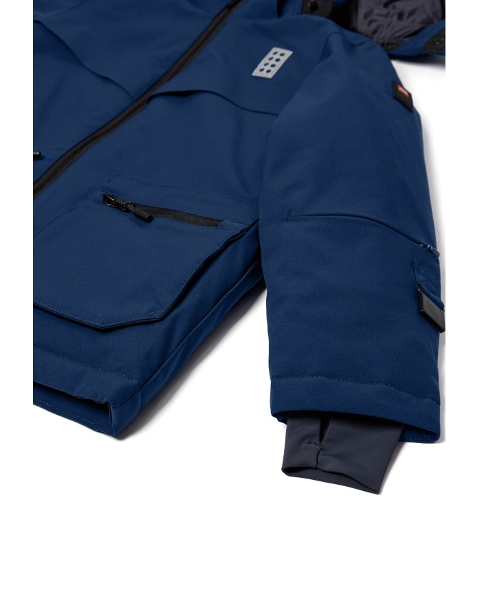 Bernumode | Lego: Winter jacket  for boy LWJAD 804 (140 g) €74.34 Functional LEGO® winter jacket for kids
Keep your child warm and comfortable during winter adventures with this LEGO® winter jacket. Designed for boys and girls, this ski jacket combines classic LEGO elements with practical features to ensure a cozy and safe experience in cold weather.
Provides protection from the rain with a 10,000 mm water column
BIONIC-FINISH ECO® water-repellent finish on the surface
Windproof design with a wind placket under the quality YKK main zipper
3M™ Scotchlite reflector badges on front and back shaped as LEGO bricks, enhancing visibility in the dark
Detachable hood mounted on a unique snap button band for safety
Safety breakaway buckle for attaching LEGO gloves to sleeves in sizes 98-140
Hidden ski pass pocket with zipper closure in the sleeve - a must when skiing
Snow skirt with gripper elastic inside the jacket to keep snow out
Stretchy inner cuff with thumbhole for added warmth and comfort
The taped seams provide additional protection against the elements
Durability: 60,000 rubs
The children's winter jacket is designed with a soft chin guard at the top of the YKK main zipper to protect the delicate skin under the chin. The ski jacket is designed with a safety breakaway buckle for attaching LEGO mittens or gloves to the sleeves in sizes 98-140. If the mitten is pulled at, it releases from the jacket sleeve, reducing the risk of accidents. The detachable hood is mounted on a unique snap button band for safety reasons. When pulled at, the hood releases from the outerwear to reduce the risk of accidents where the kids are stuck on something with the hood. The elastic at the hood opening and reflective thread in the zipper puller at front pockets add to the jacket's functional design. Thanks to the many awesome ski features, the water- and windproof winter jacket is ideal for skiing as well as everyday life.
Specifications• -15 degrees Celsius / 5 Fahrenheit.• 3M reflective badge.• BIONIC-FINISH ECO® water-repellent finish on the surface.• Breathability: 4.000 g/m2/24hours.• Detachable hood.• Durability: 60.000 rubs.• Elastic at hood opening.• Reflective thread in zipper puller at front pockets.• Safety breakaway buckle for attaching the gloves to sleeves. The buckle releases when pulling the gloves.• Safety breakaway buckle only in size 98-140.• Ski pass pocket with zipper closure.• Snow skirt with gripper elastic inside jacket.• Stretchy inner cuff with thumbhole.• Taped seams.• Water column: 10.000 mm.• Wind placket under main zipper.• Windproof.• YKK main zipper.• Zipper pocket(s) on front.
 Bernumode | Lego: Winter jacket  for boy LWJAD 804 (140 g) €74.34 Functional LEGO® winter jacket for kids
Keep your child warm and comfortable during winter adventures with this LEGO® winter jacket. Designed for boys and girls, this ski jacket combines classic LEGO elements with practical features to ensure a cozy and safe experience in cold weather.
Provides protection from the rain with a 10,000 mm water column
BIONIC-FINISH ECO® water-repellent finish on the surface
Windproof design with a wind placket under the quality YKK main zipper
3M™ Scotchlite reflector badges on front and back shaped as LEGO bricks, enhancing visibility in the dark
Detachable hood mounted on a unique snap button band for safety
Safety breakaway buckle for attaching LEGO gloves to sleeves in sizes 98-140
Hidden ski pass pocket with zipper closure in the sleeve - a must when skiing
Snow skirt with gripper elastic inside the jacket to keep snow out
Stretchy inner cuff with thumbhole for added warmth and comfort
The taped seams provide additional protection against the elements
Durability: 60,000 rubs
The children's winter jacket is designed with a soft chin guard at the top of the YKK main zipper to protect the delicate skin under the chin. The ski jacket is designed with a safety breakaway buckle for attaching LEGO mittens or gloves to the sleeves in sizes 98-140. If the mitten is pulled at, it releases from the jacket sleeve, reducing the risk of accidents. The detachable hood is mounted on a unique snap button band for safety reasons. When pulled at, the hood releases from the outerwear to reduce the risk of accidents where the kids are stuck on something with the hood. The elastic at the hood opening and reflective thread in the zipper puller at front pockets add to the jacket's functional design. Thanks to the many awesome ski features, the water- and windproof winter jacket is ideal for skiing as well as everyday life.
Specifications• -15 degrees Celsius / 5 Fahrenheit.• 3M reflective badge.• BIONIC-FINISH ECO® water-repellent finish on the surface.• Breathability: 4.000 g/m2/24hours.• Detachable hood.• Durability: 60.000 rubs.• Elastic at hood opening.• Reflective thread in zipper puller at front pockets.• Safety breakaway buckle for attaching the gloves to sleeves. The buckle releases when pulling the gloves.• Safety breakaway buckle only in size 98-140.• Ski pass pocket with zipper closure.• Snow skirt with gripper elastic inside jacket.• Stretchy inner cuff with thumbhole.• Taped seams.• Water column: 10.000 mm.• Wind placket under main zipper.• Windproof.• YKK main zipper.• Zipper pocket(s) on front.