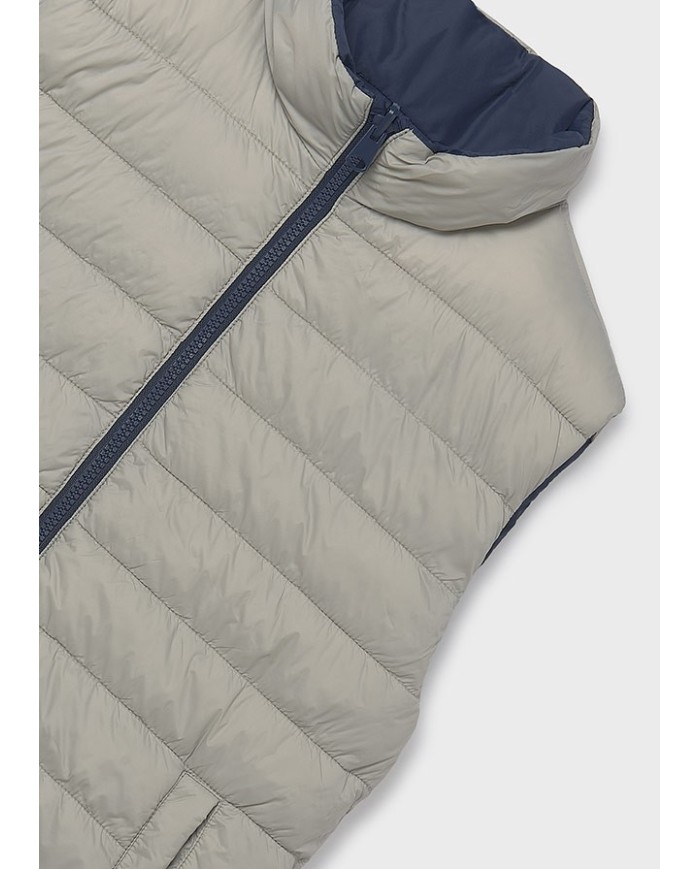 Bernumode | Mayoral: Boys’ Reversible Vest €34.30 Made with recycled polyester. Boys' vest. Hooded collar. Central front zipper closure. Soft polyester inner lining. Functional front pockets. This model features a reversible design.